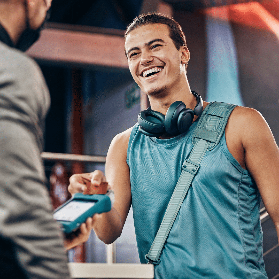 312 » PEMF Recovery Plus man using a credit card machine for payment, personal trainer, and fitness coach
