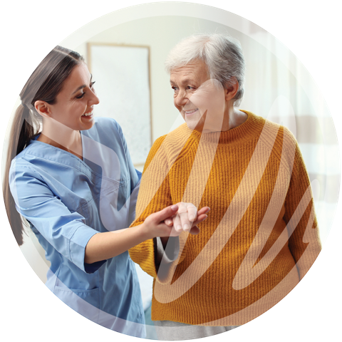 Compassionate Care for Seniors with Parkinson’s » PEMF Recovery Plus Smiling caregiver supporting an elderly woman during assisted mobility.