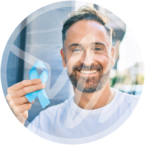 Prostate Cancer Awareness and Support » PEMF Recovery Plus Smiling man holding a blue ribbon representing prostate cancer awareness.