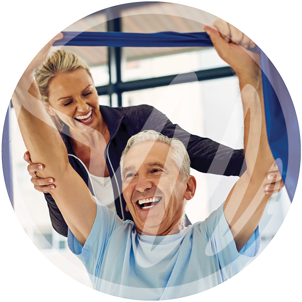 Senior Resistance Band Therapy Session » PEMF Recovery Plus Older man smiling while performing resistance band stretches with support from a female physical therapist in a bright rehab setting.